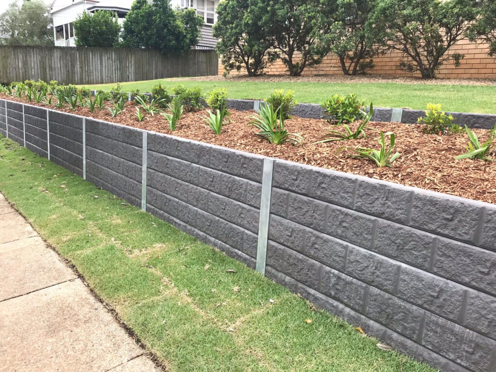 Concrete sleeper retaining wall installation process by James W Landscaping In Melbourne